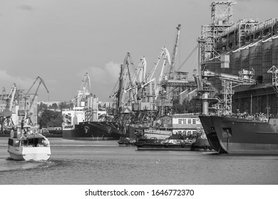 ships for grain transportation and port cranes for loading.River port terminal. Transportation of agricultural products. Soft focus