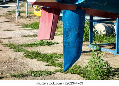 A Ship's Rudder Under The Ship On The Shore Of The Harbor