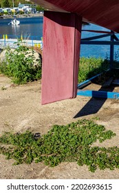 A Ship's Rudder Under The Ship On The Shore Of The Harbor