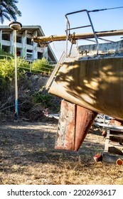 A Ship's Rudder Under The Ship On The Shore Of The Harbor