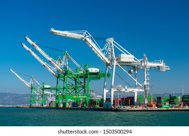 Ship-to-shore gantry cranes at berth of Ben E. Nutter Terminal servicing Evergreen Marine Corporation  and STS shipping containers - Oakland, California, USA - Circa, 2019