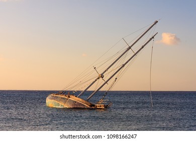 Shipwrech. Sinking Yacht And Sunset Colors