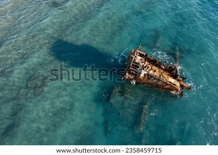 Shipwreck of an abandoned ship on a rocky coast in the ocean. Akrotiri Beach in Cyprus