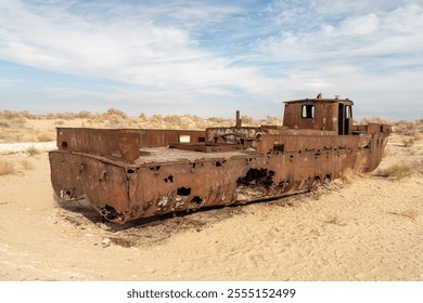 shipwreck. Ecological disaster of the Aral Sea. Rusty ships at the ship graveyard in Aral sea port town Moynaq, Uzbekistan. Old abandoned ship on the shore of drying up Aral Sea. - Powered by Shutterstock