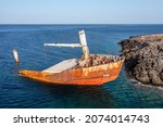 Shipwreck of Nordland at seaside of village Diakofti Kythira island Greece. Famous navagio of Russian cargo half sunk rusty ship is popular tourist attraction at Kythera. Blue sea background.