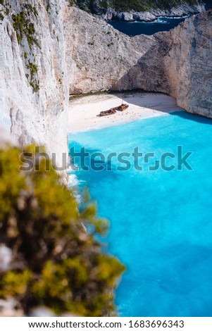 Shipwreck on Navagio beach. Azure turquoise sea water and paradise sandy beach. Famous tourist visiting landmark on Zakynthos island, Greece