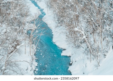 Shirahige Waterfall with Snow in winter, Biei river flow into Blue Pond. landmark and popular for attractions in Hokkaido, Japan. Travel and Vacation concept - Powered by Shutterstock