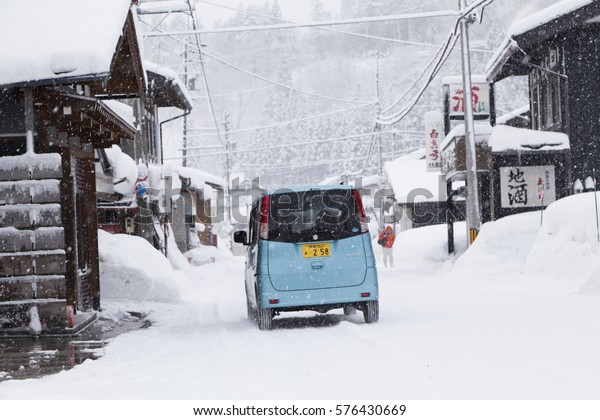 Shirakawa, Japan - Feb 2,2017 : The car running in snow\
at  Hatotani village near Shirakawa go in Shirakawa, Japan on\
February 2,2017. 
