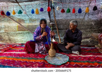 Shiraz, Iran - May 11, 2018: Qashqai nomadic family smoking hookah. Qasqhai are nomadic people living in temporary villages.