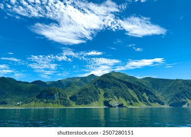 Shiretoko mountain range with blue sky in summer . - Powered by Shutterstock