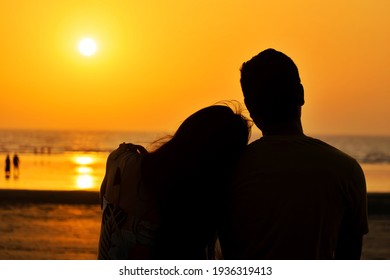 Shirgaon, Palghar, Mumbai - 13 March 2021 A beautiful silhouette of a couple enjoying their quality time at a beach during sunset. Love, life, hug, kiss, marriage, engagement, propose, romance concept