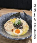 Shiro chicken ramen :  kind of food from Japan, made by noodles with a thick chicken broth and the other condiment such as grilled chicken, nori, green onion, sweet corn, and chilli oil