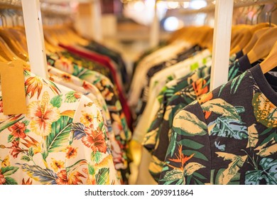 shirt and clothes for aloha summer hanging on a shelf in fashio and clothing store