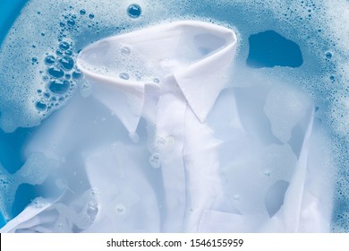 Shirt soak in powder detergent water dissolution, washing  cloth. Laundry concept
