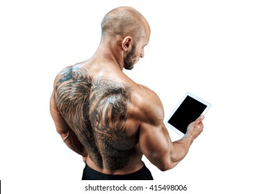 Shirtless Bald Tatooed Man Using Tablet Stand Back. Isolate.