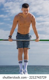 Shirtless Boy Practicing Pole Sport