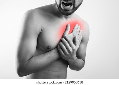 Shirtless Man Body Torso Holding Chest Pain Due To Heart Attack, Pain Zone Highlighted In Red Glow Isolated In Grey Background.