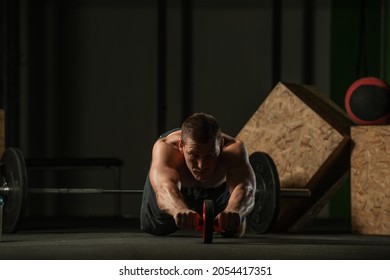 Shirtless Pro Athlete Doing Russian Twist Abs Workout. Close Up Photo Of A Fit Male Athlete Doing Indoor Training.