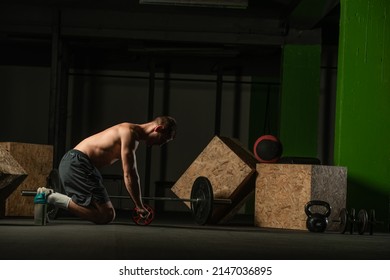 Shirtless Pro Athlete Doing Russian Twist Abs Workout. Close Up Photo Of A Fit Male Athlete Doing Indoor Training.