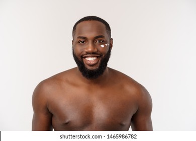 Shirtless Young Brutal African American Man Applying Facial Cream On His Face. Close Up Portrait,men's Beauty. Skin Care