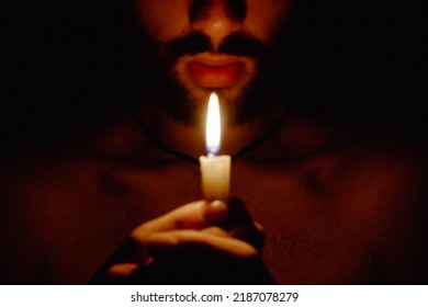 Shirtless Young Man Holds A Candle In His Hands, Opening The Third Eye With Fire