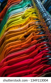 Shirts Sorted In Color Order On Hangers On A Shop Wardrobe Closet Rail