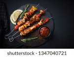 Shish kebab with mushrooms, cherry tomato and sweet pepper, Grilled meat skewers. Top view, copyspace.