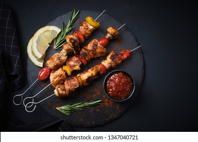 Shish kebab with mushrooms, cherry tomato and sweet pepper, Grilled meat skewers. Top view, copyspace.