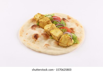 shish tikka sandwich curry tandoori chicken with salad in open naan bread isolated high view angle on white background