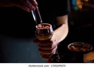 Shisha hookah with red hot coals. Modern hookah with coconut charcoal for relax and shisha smoke. Hookah and sparks from coals. Shisha, spark, hookah sparks.