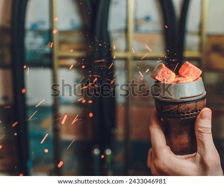 Shisha hookah with red hot coals. Sparks from breathe. Modern hookah with coconut charcoal for relax and shisha smoke. Hookah and sparks from coals. Another view. Shisha, spark,spark, hookah sparks