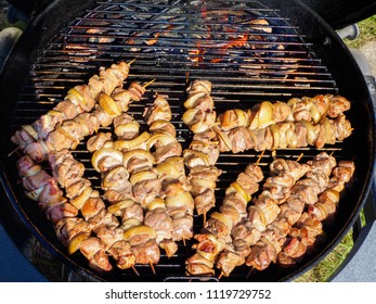 Shishkebab Cooked On Indirect Heat On A Charcoal Grill. Meat On With Onion On Wooden Skewers