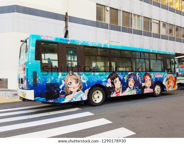 Shizuoka, JP - NOVEMBER 2, 2018: The local city\
loop-bus that wrapping with Japanese cartoon characters, running on\
the asphalt road in Numazu\
City.