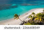 shoal bay east, Anguilla. Couple walking on the beach. Beautiful beach with turquoise sea. Crystalline waters of white sand, with plenty of shade from coconut trees. The best beach in the Caribbean.