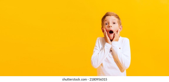 Shock, Scare, Surpirse. Portrait Of Scary Little Boy, Emotional Kid Isolated On Bright Yellow Background With. Concept Of Child Emotions, Facial Expression, Fashion. Flyer With Copy Space For Ad.