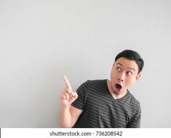 Shock And Surprise Face Of Asian Man Point On Empty Space.