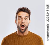 Shock, surprise and portrait of a man in a studio with an amazed facial expression or attitude. Shocked, amazing news and male model with a wtf, omg or wow face gesture isolated. by white background.