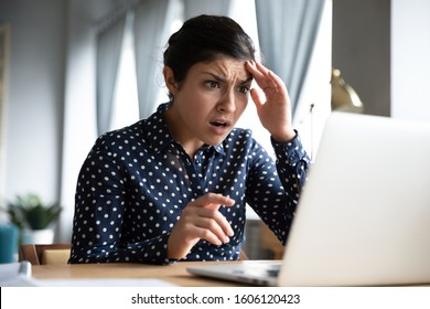 Shocked Afraid Worried Young Indian Girl Look At Laptop Computer Screen Terrified Read Bullying Social Media Message Feel Bad Surprise Stress Panic About Stuck Computer Problem Concept At Home Office