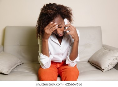 Shocked african american woman receiving bad news at phone - Powered by Shutterstock