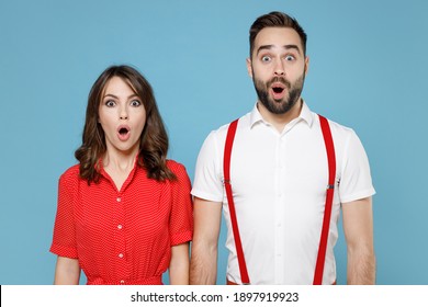 Shocked Amazed Young Couple Two Friends Man Woman Wering White Red Clothes Keep Mouth Open Looking Camera Isolated On Pastel Blue Color Background Studio Portrait. St. Valentine's Day Holiday Concept