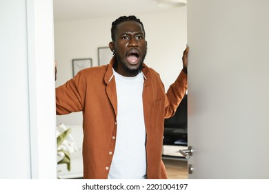 Shocked Angry Black Man Opening Door, Looking At Something Shocking And Shouting, Standing With Open Mouth. Overwhelmed Guy Expressing Embarrassment