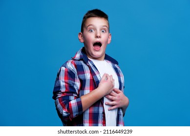 Shocked And Appalled Young Teenage Boy Making A Gasp Expression, Blue Background