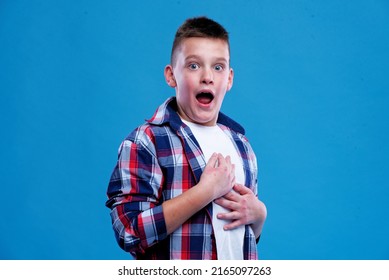 Shocked And Appalled Young Teenage Boy Making A Gasp Expression, Blue Background