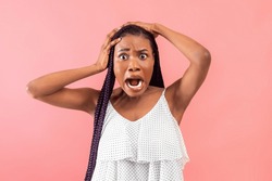Shocked Black Woman Looking At Camera With Open Mouth, Grabbing Head In Terror On Pink Studio Background. Millennial African American Lady Feeling Scared, Shouting OMG In Panic