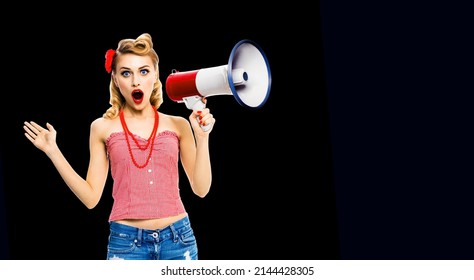 Shocked Blond Woman Holding Mega Phone And Shout Something. Girl In Red Pinup Style With Wide Open Mouth, On Dark Black Background. Female Model In Retro Vintage Studio Concept.