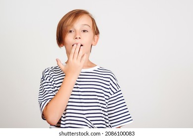 Shocked Boy Cover Mouth With Hands. Surprised Fun Impressed Kid Forgetting Something. Face Emotion And Expression. Oops, What Did I Do. Oh No. Boy Thinking About Secret. Face Studio Portrait Of Boy.