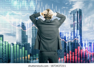 Shocked businessman looking at decreasing graph on city background. Trade and investment concept. Multiexposure