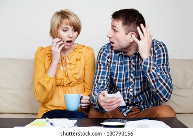 Shocked Couple Paying Bills. She Just Buy Too Much.