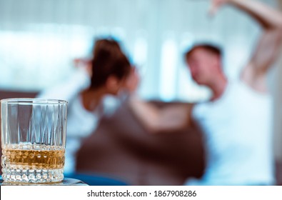 Shocked Couple Waking Up In Messy Room After Celebration Party At Home, Floor Covered With Garbage And Empty Bottles
