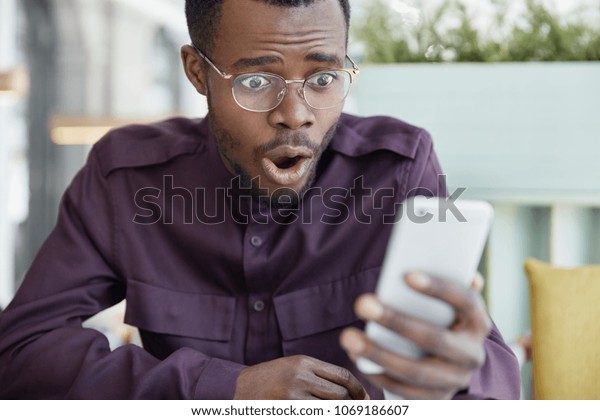 Shocked Dark Skinned Young Man Spectacles Stock Photo Edit Now 1069186607